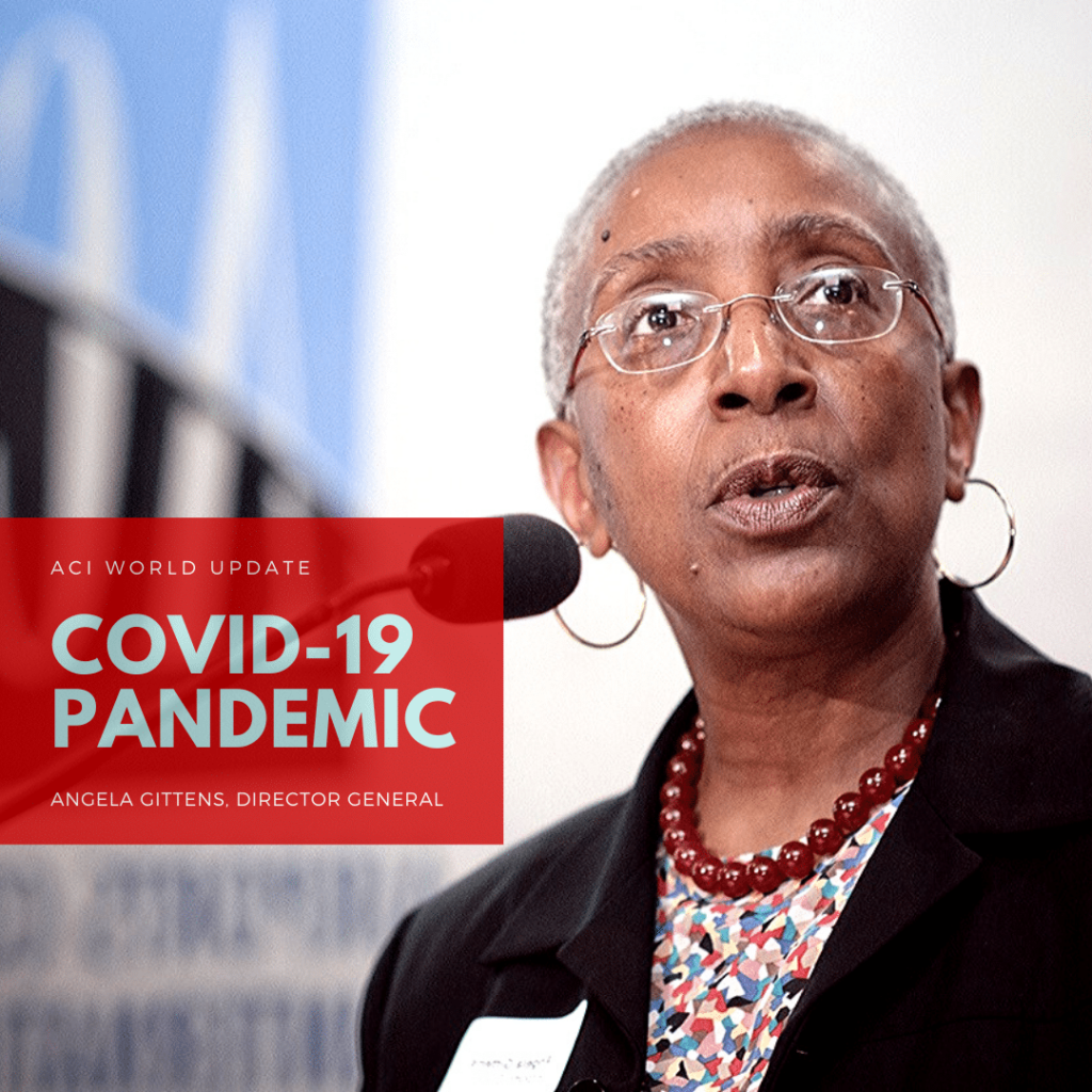 An older woman with short gray hair and glasses speaks at a microphone. A red box on the image reads: COVID-19 Pandemic. Angela Gittens, Director General. ACI World Update.