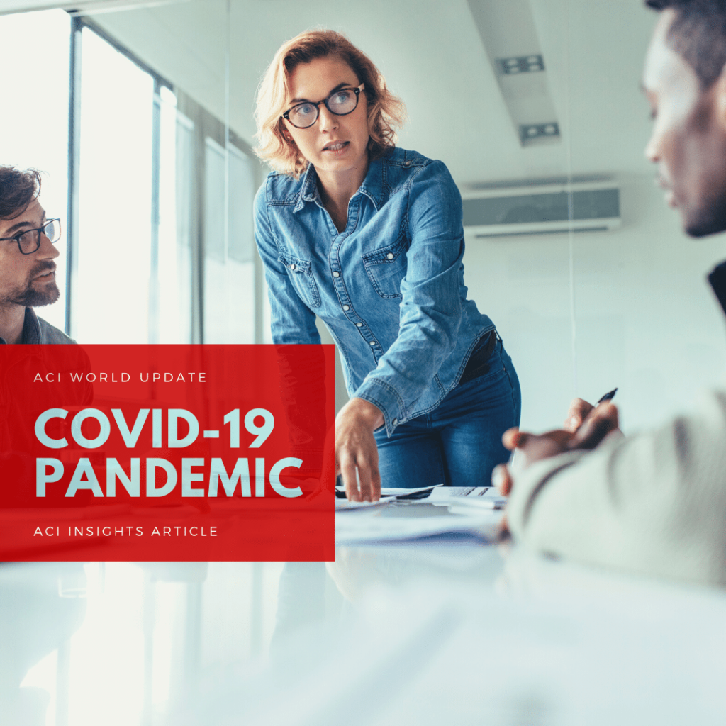 A woman stands and speaks to two seated colleagues in a modern office. A red box with white text reads: COVID-19 Pandemic, ACI World Update, ACI Insights Article.