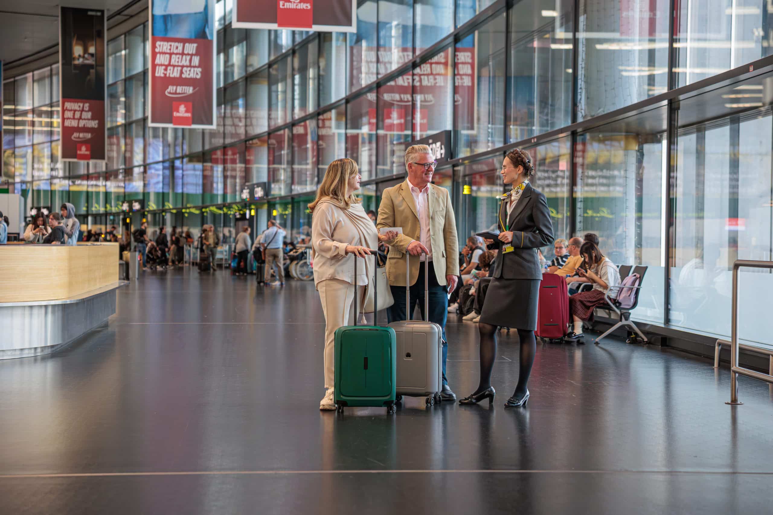 Vienna Airport Terminal 3, smiling passengers and airport employee